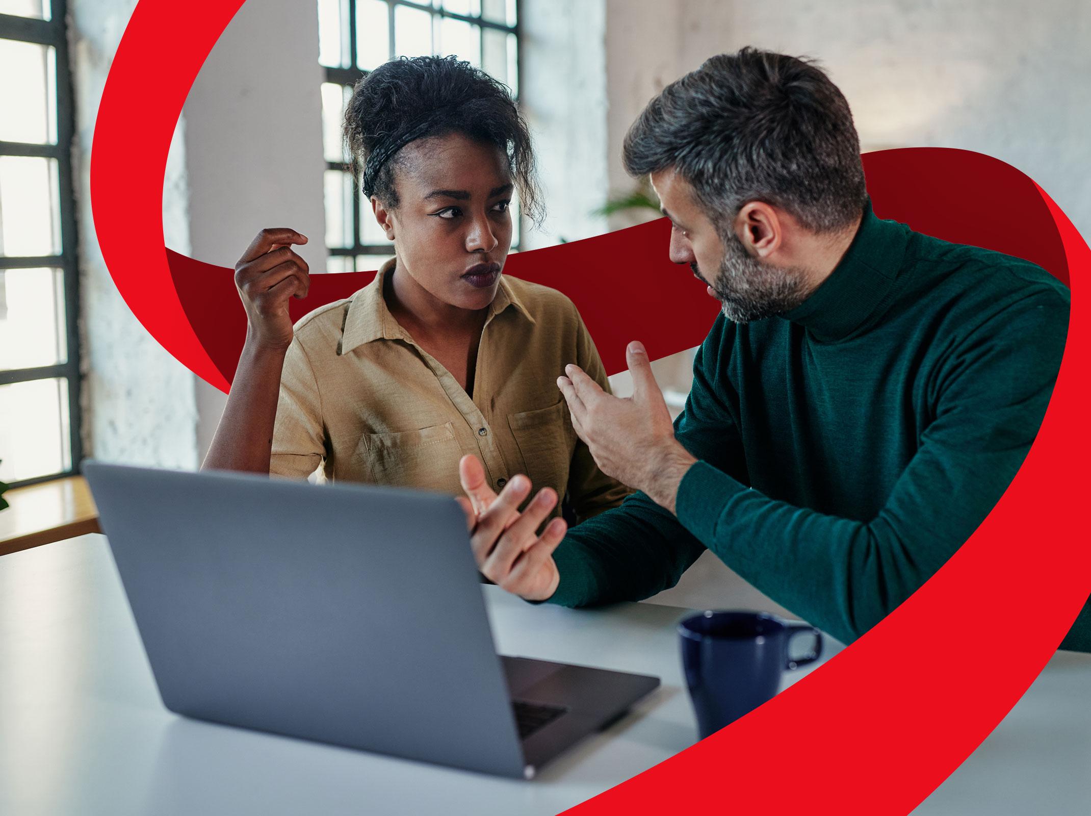 Two business professionals using conflict management skills to solve an issue