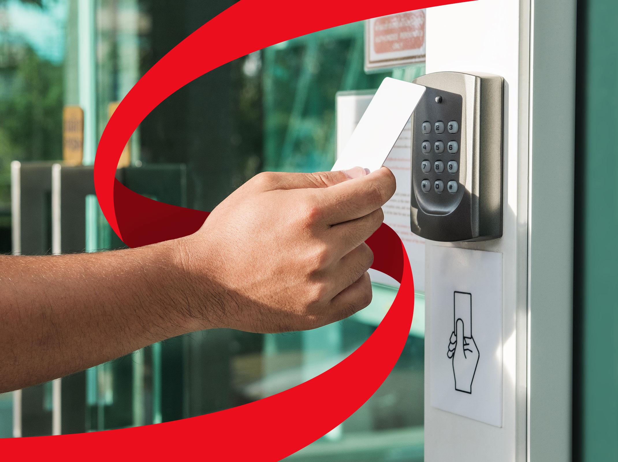 A person scanning a badge at a secured door.