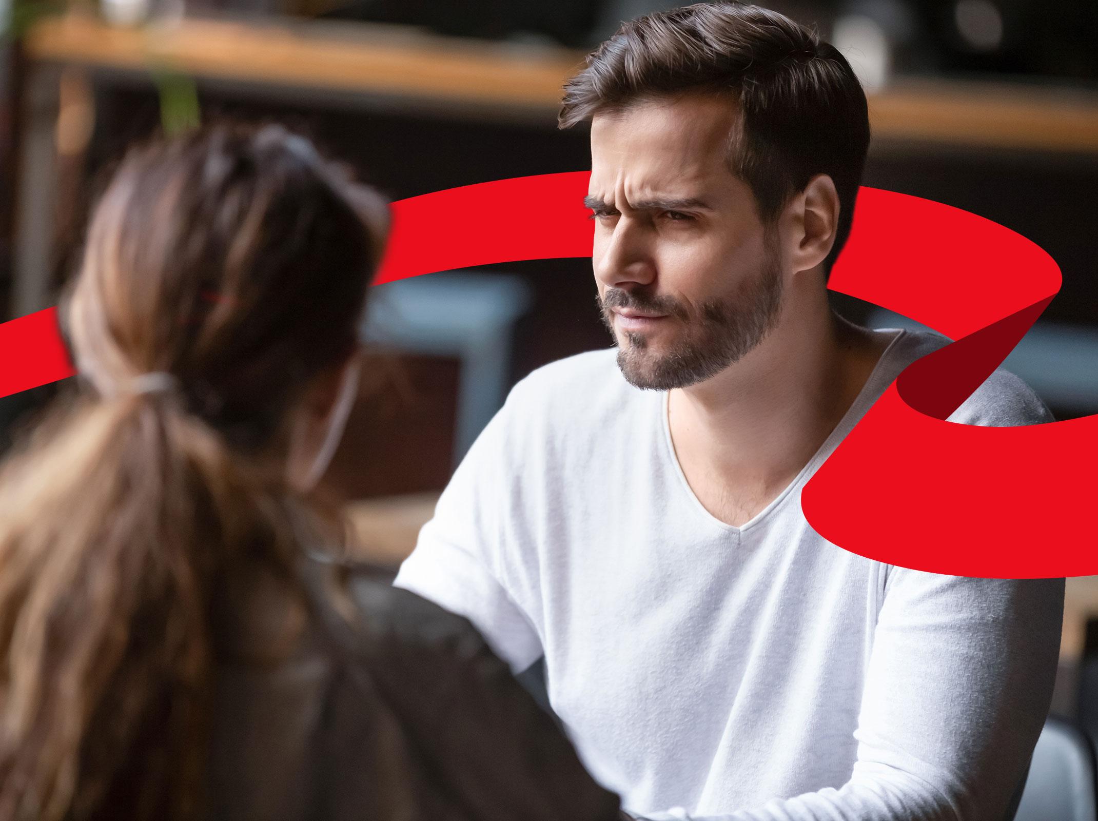 Business professional looking skeptically at a colleague in a business setting