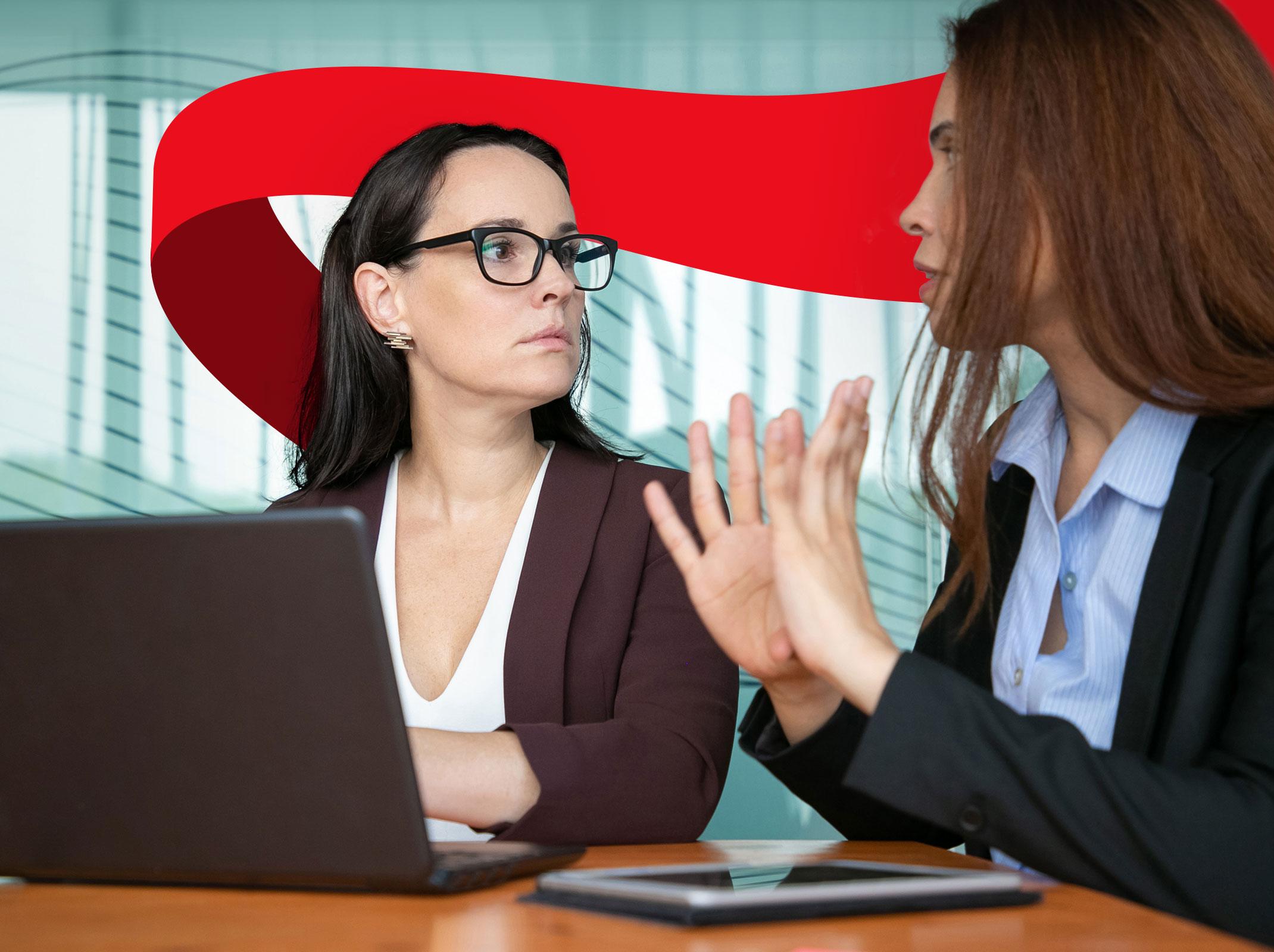 Two business professionals having an emotional conversation that appears to contain conflict in a business setting.