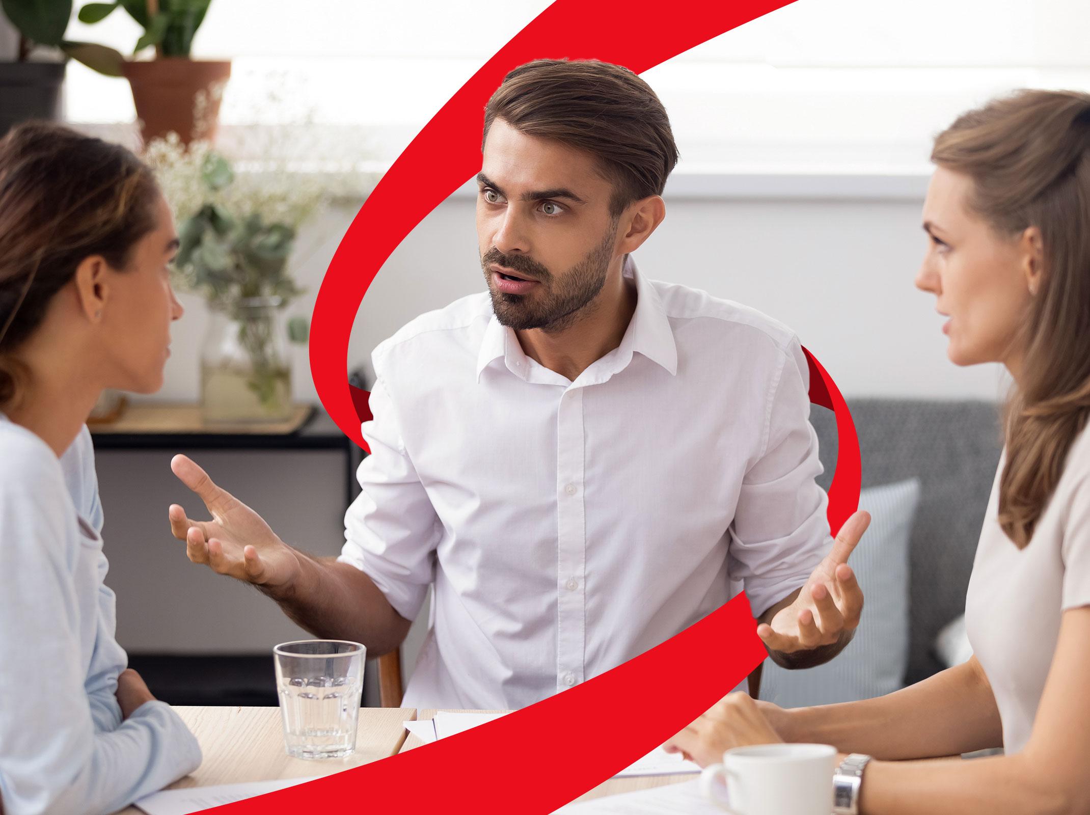 Business professionals conversation at table that appears to have conflict