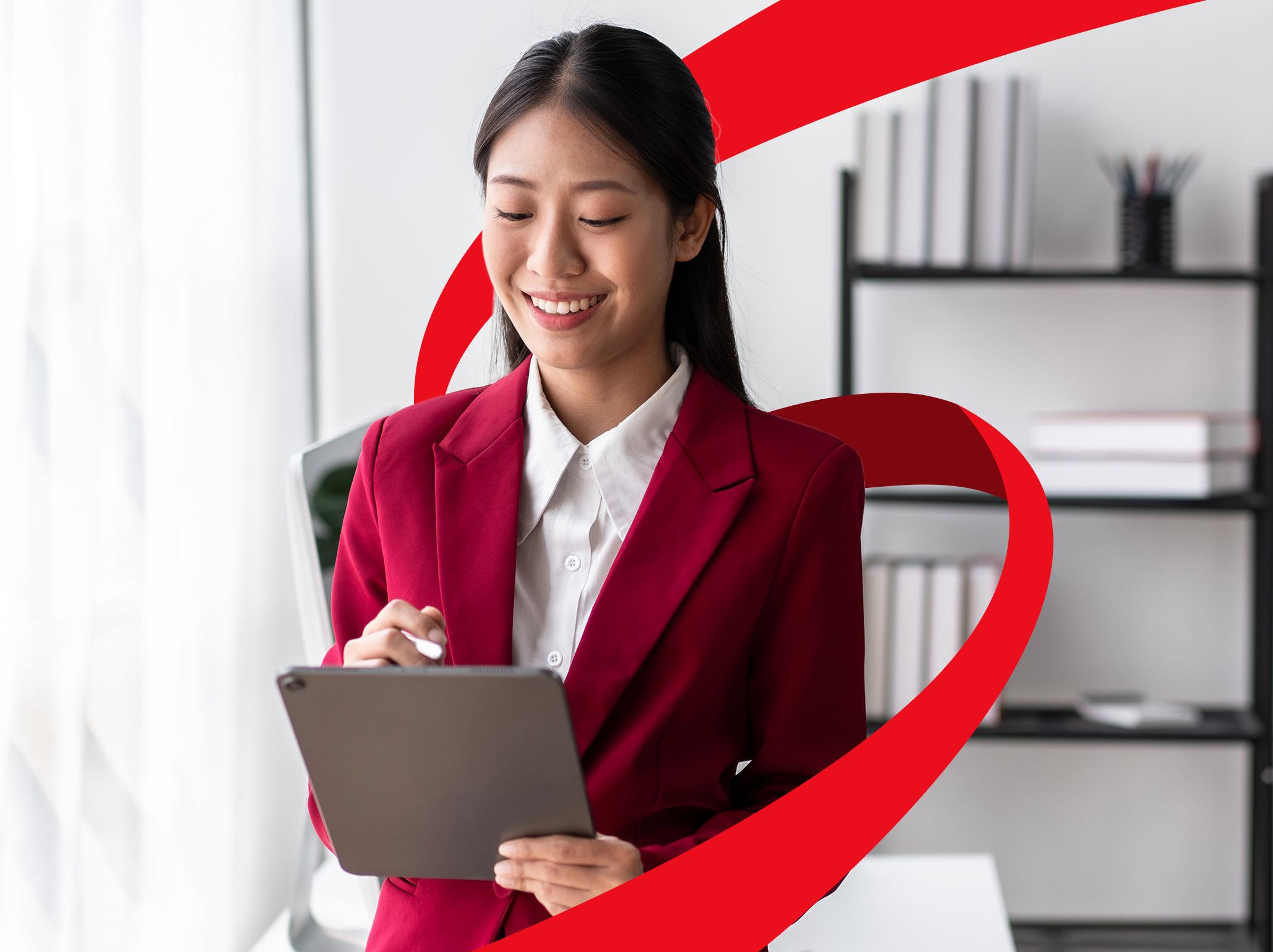 Administrative professional smiling while working on a computer