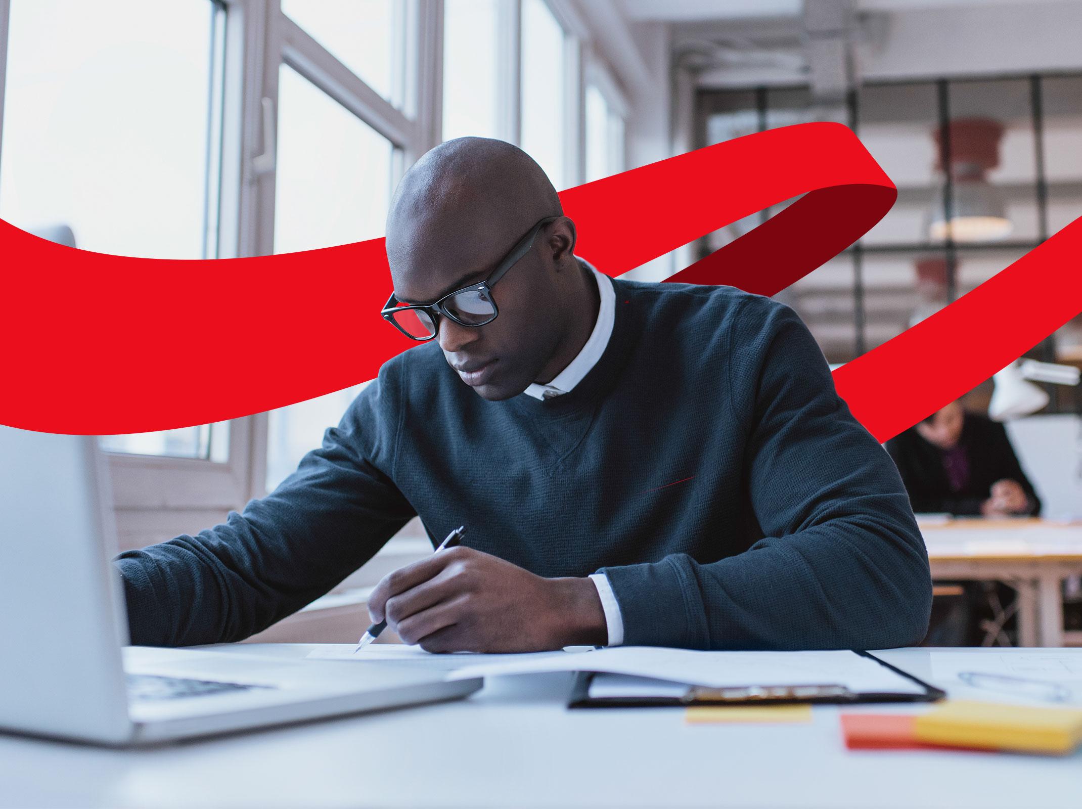 Business professional writing and using a computer